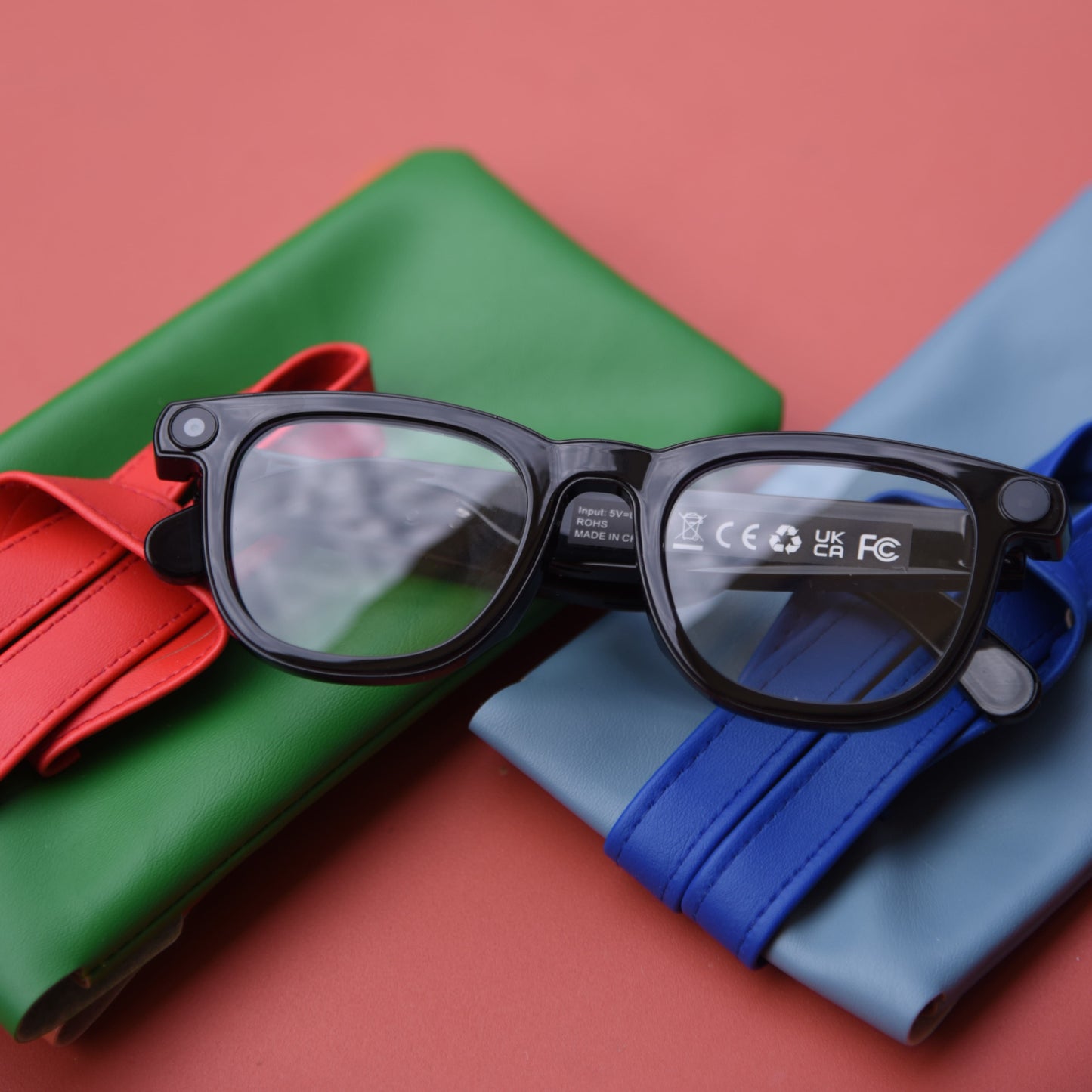 Black eyewears with certification marks on a red background